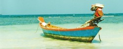 Boat on pristine beach in Thailand