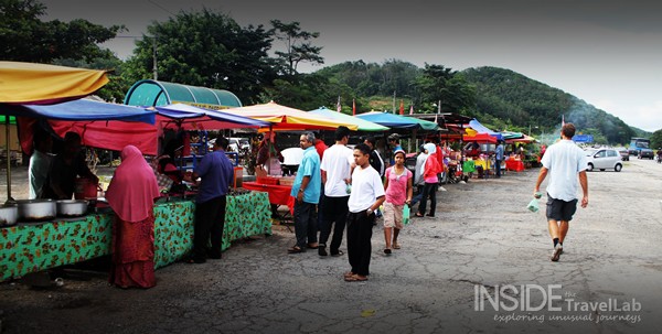 Foreign Man walking along the road - crowded Malaysian street food