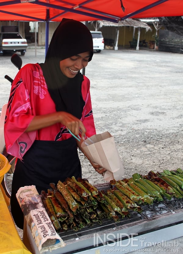 Malaysia woman serving banana wraps