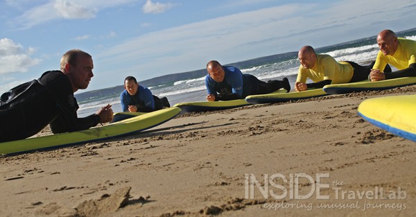 Lying on the sand during a surf lesson