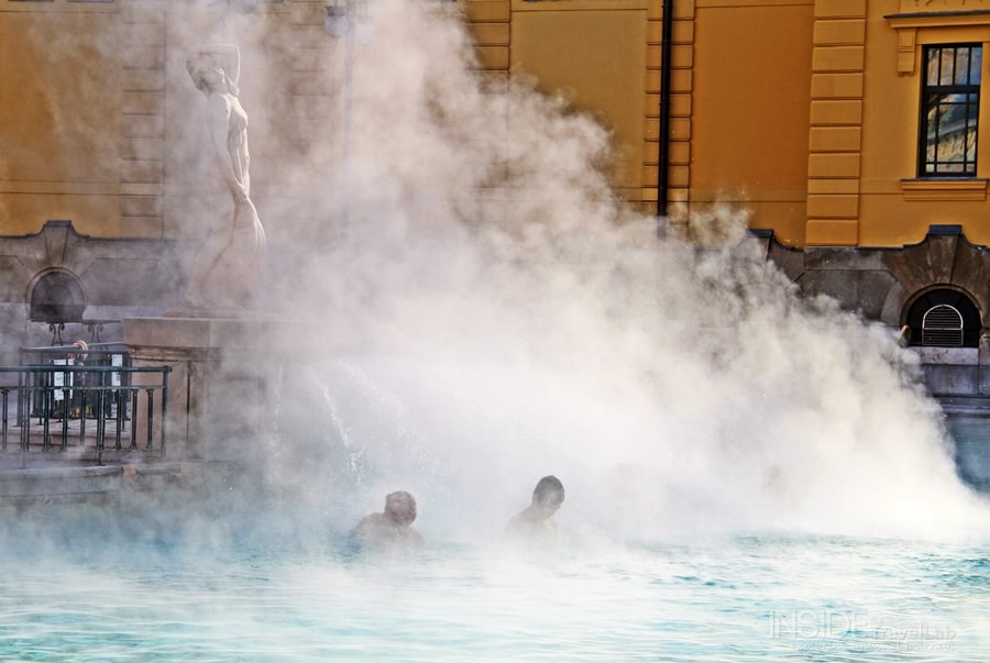 Baths in Budapest two men beneath steam