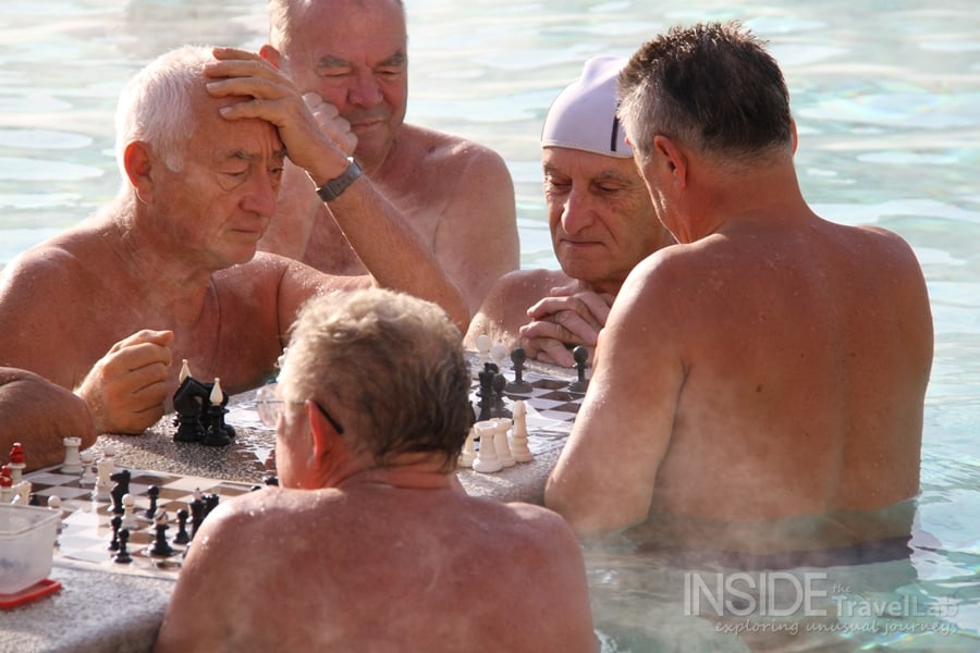 Medium shot playing chess in budapest baths