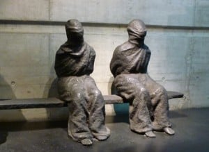 Shackled Figures with faces covered and hands tied behind their back at the entrance to the Red Cross & Crescent Museum in Geneva, Switzerland