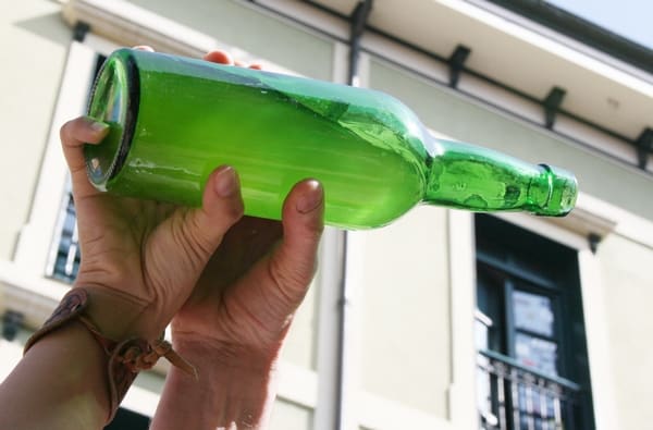 Asturias highlights - pouring cider from a green bottle
