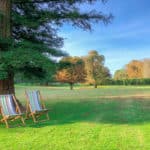 Best sustainable travel blogs image - deckchairs in garden with trees
