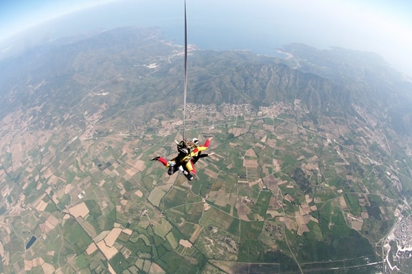 All about a tandem skydive over spain: fields below skydivers