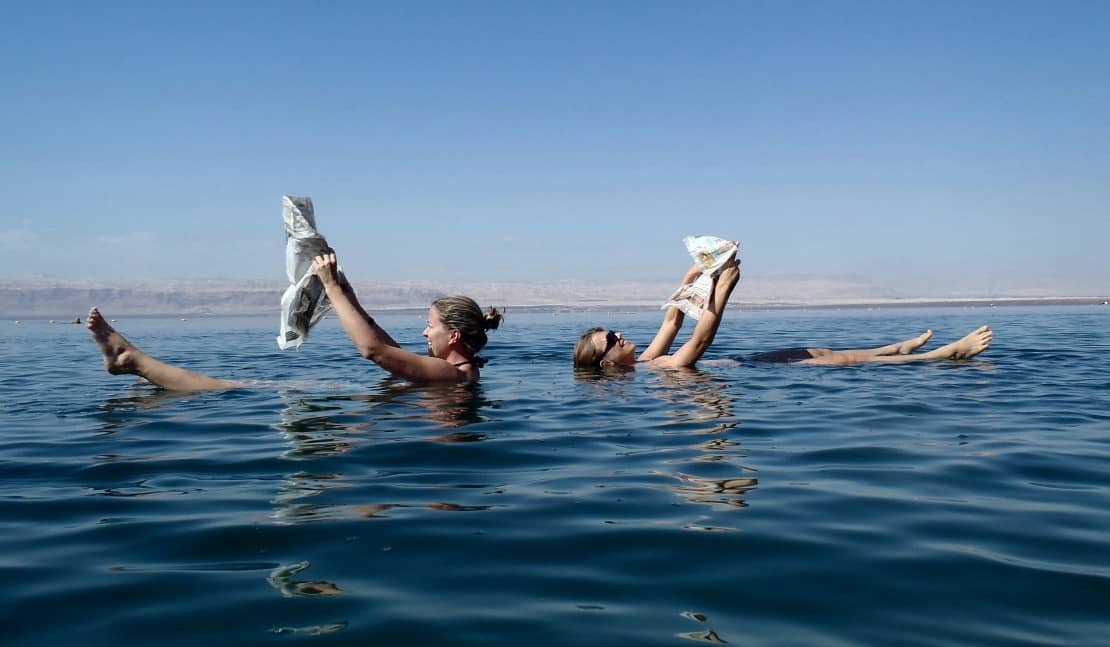 Reading newspapers while floating in the Dead Sea