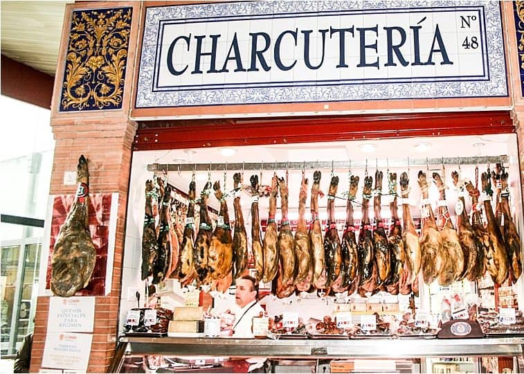 Hanging charcuterie at Triana Market in Seville Spain