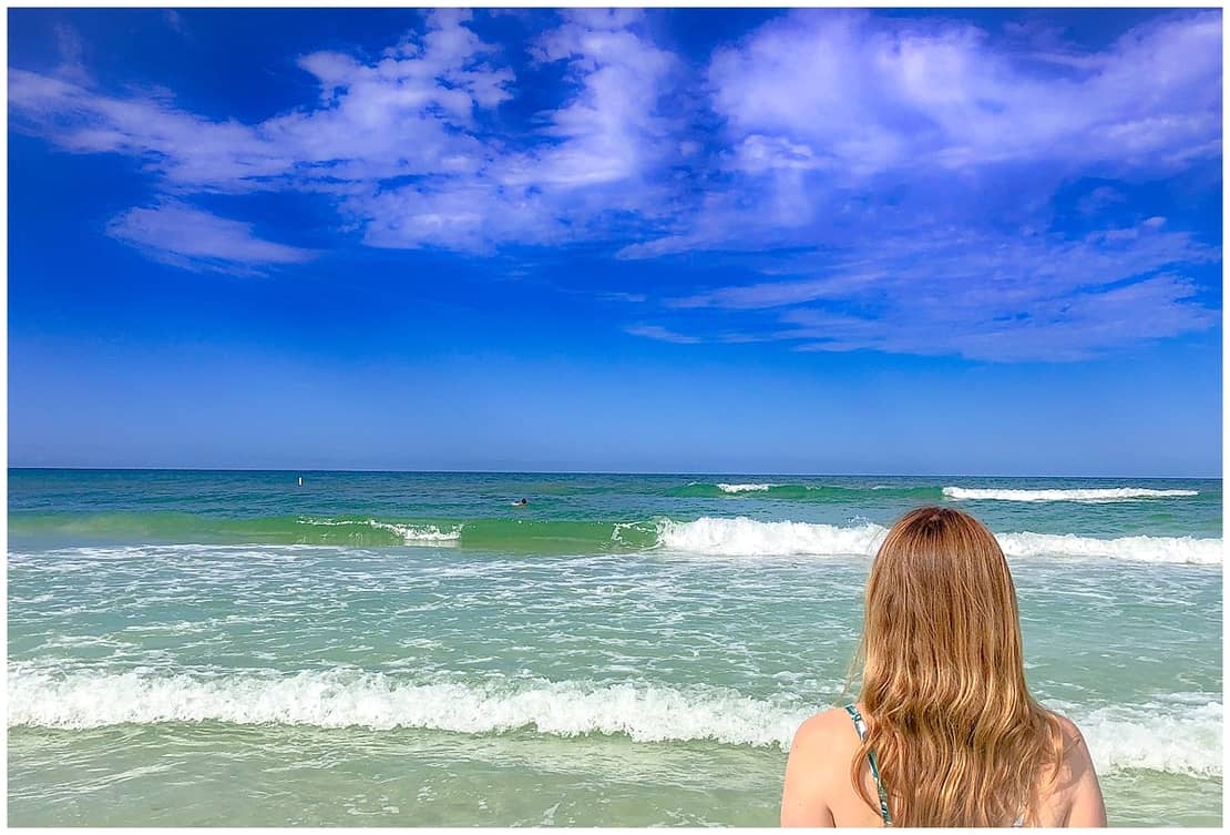 Abigail King looking out across the ocean at Clearwater, Florida, USA