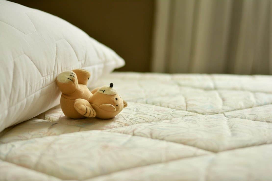 Toddler travel toy teddy on mattress