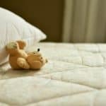 Toddler travel toy teddy on mattress