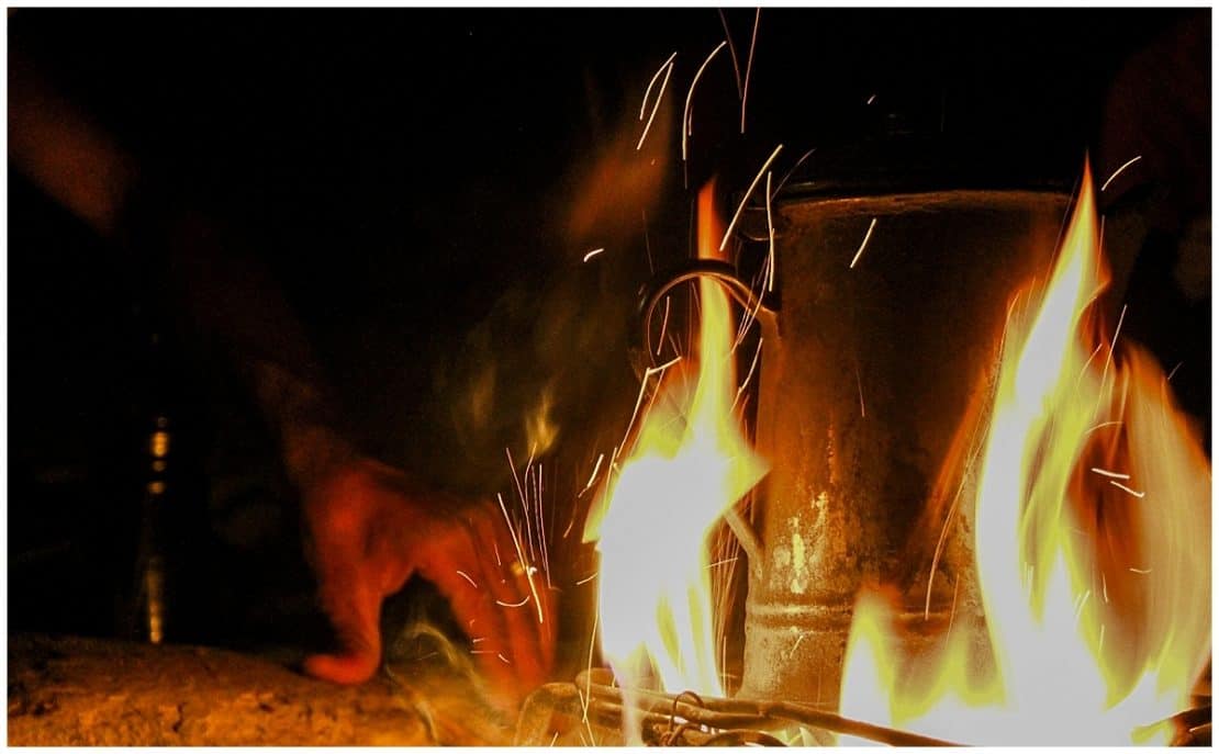 Preparing Arabic coffee in the desert around a fire in Jordan at Feynan Ecolodge Dana Nature Reserve