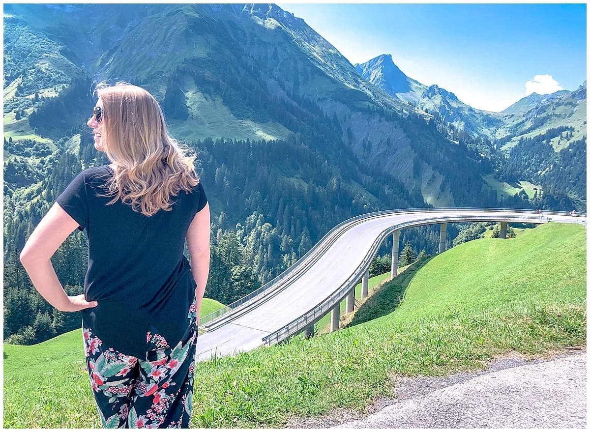 Abigail King in Austria in front of a curving road