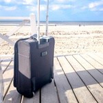 Suitcase in front of a beach