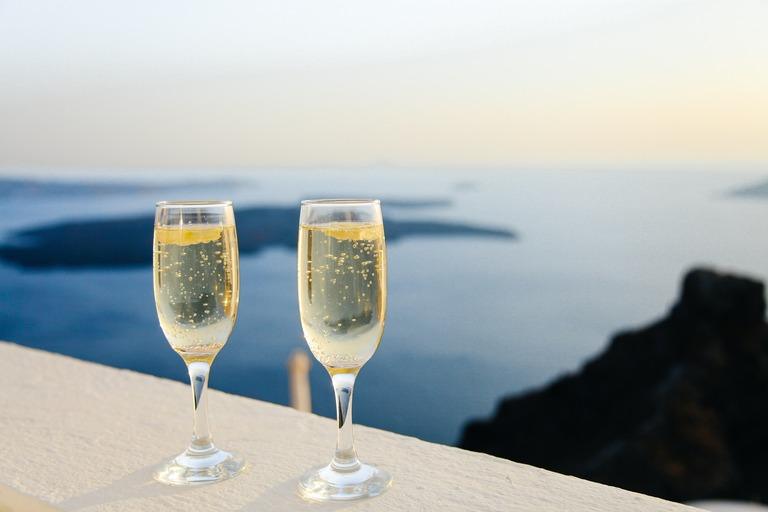 Two champagne glasses near the sea