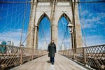 Destinations of the world hero image Abigail King walking on Brooklyn Bridge