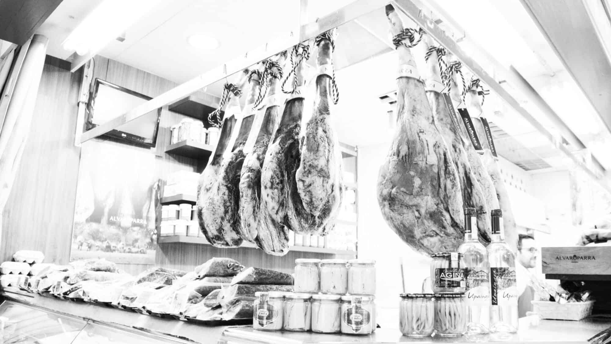 Black and white view of jamon in Seville market