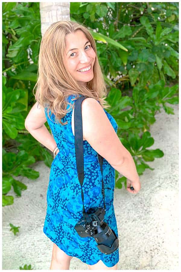 Photographer Abigail King with camera in the Maldives