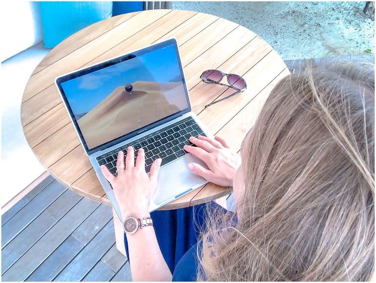 Woman working at laptop with sunglasses