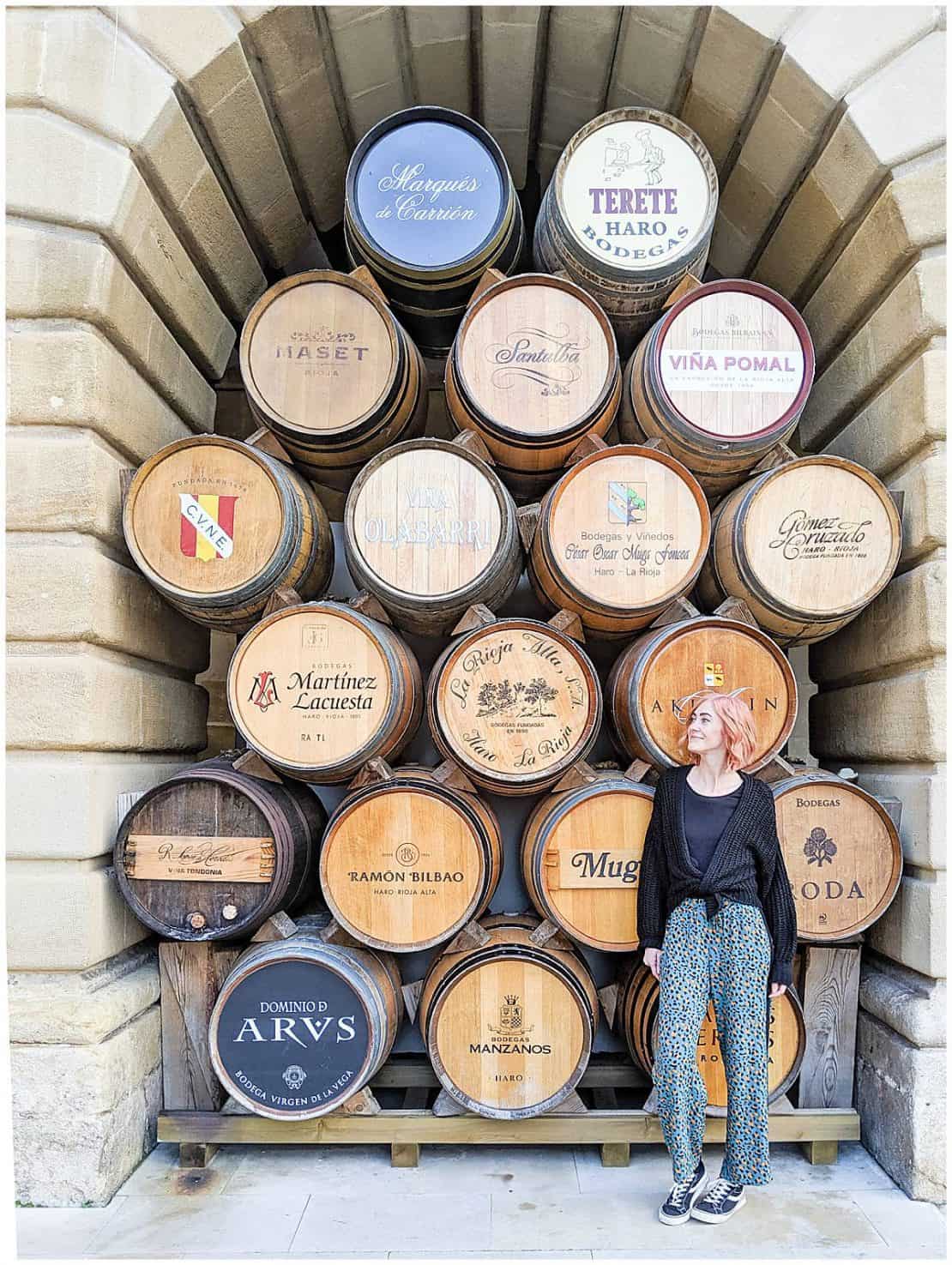 Spain - La Rioja - Haro - woman standing in front of barrels