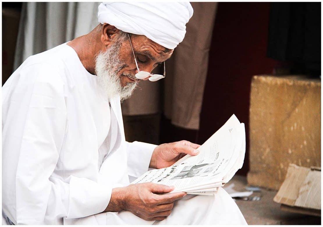 Egypt - Philae Temple - Merchant reads newspaper