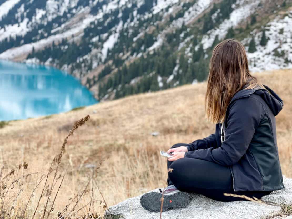 Outdoorsy girlfriend - adventurous woman looking beside a lake
