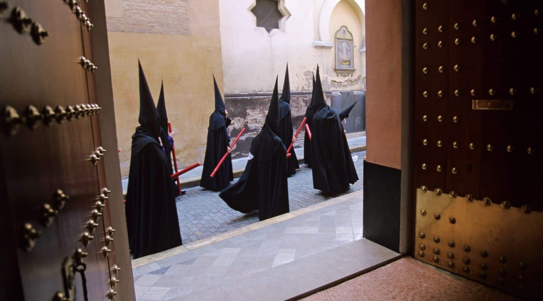 Spain - Seville - Holy Week - Semana Santa - Nazarenos Walking Past Open Doors