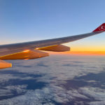 Sunrise through a plane window of a long haul flight