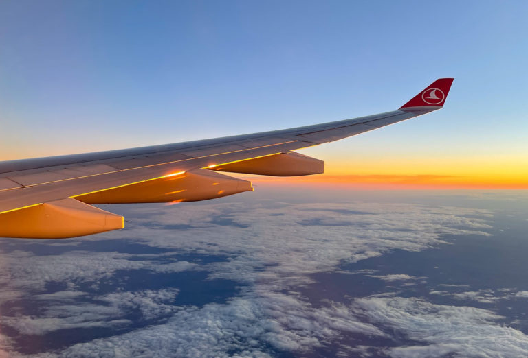 Sunrise through a plane window of a long haul flight