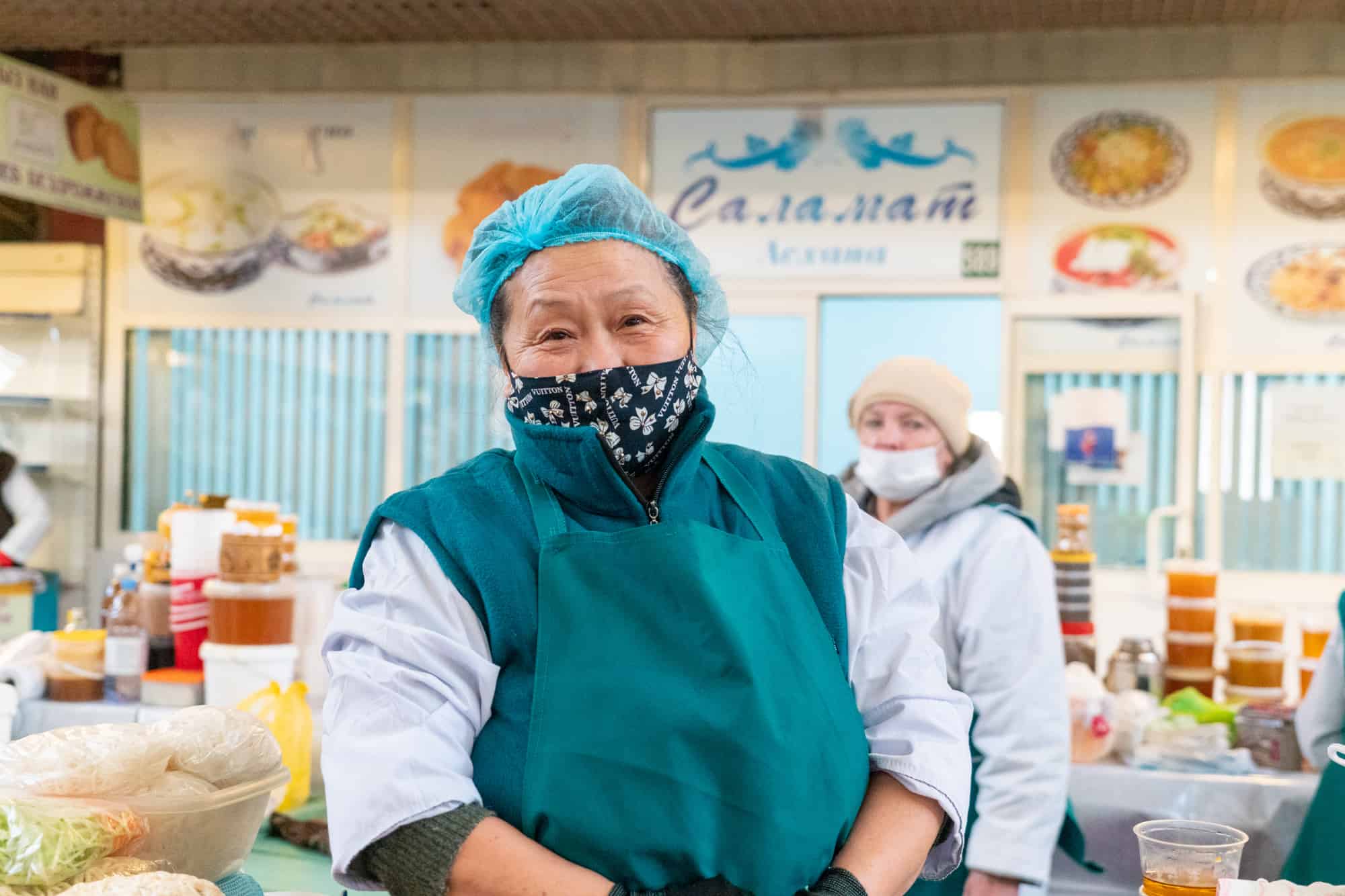 Kazakhstan - Vendor at indoor food market in Almaty