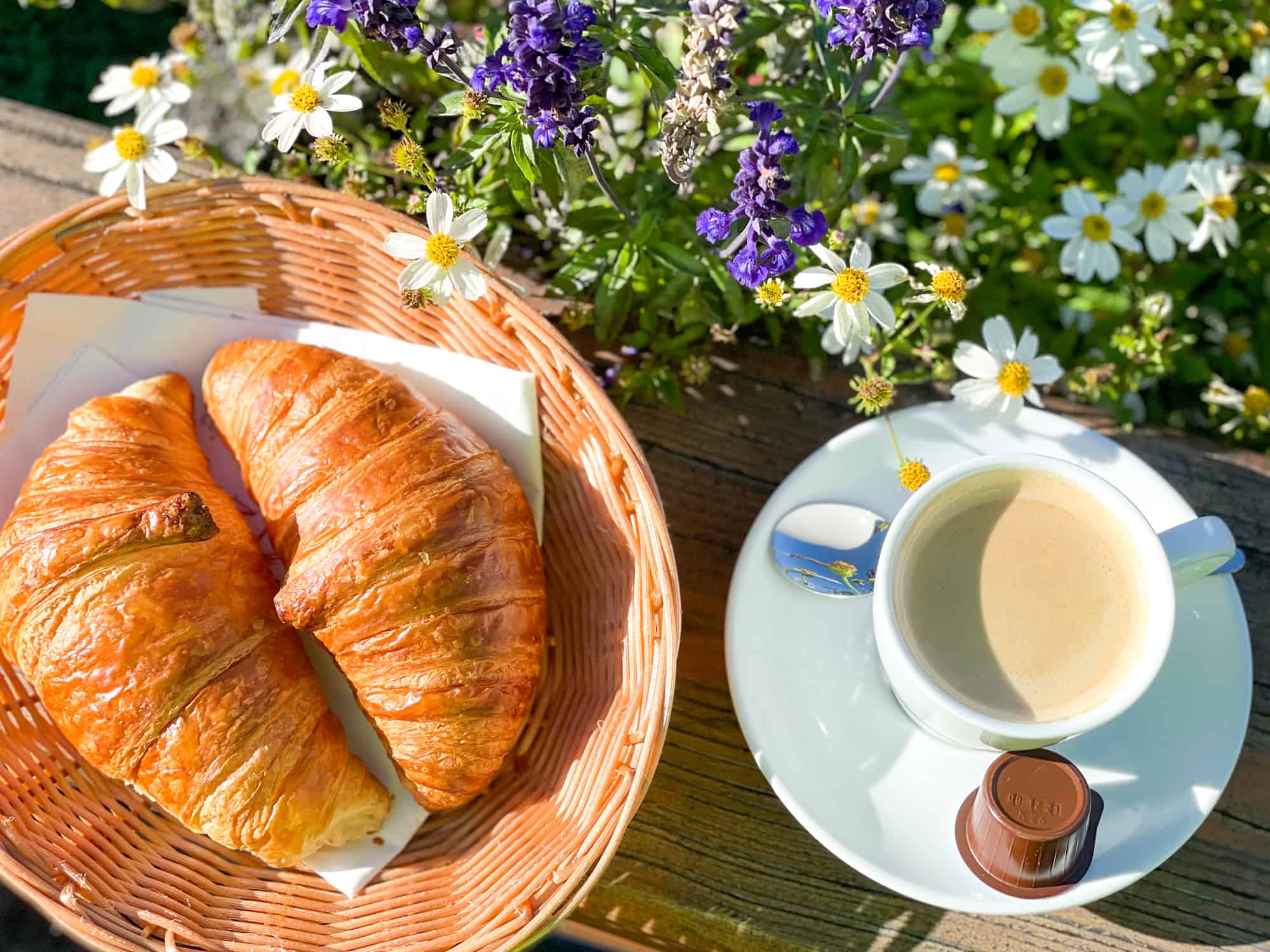 Summer in Switzerland coffee and croissant with flowers outside