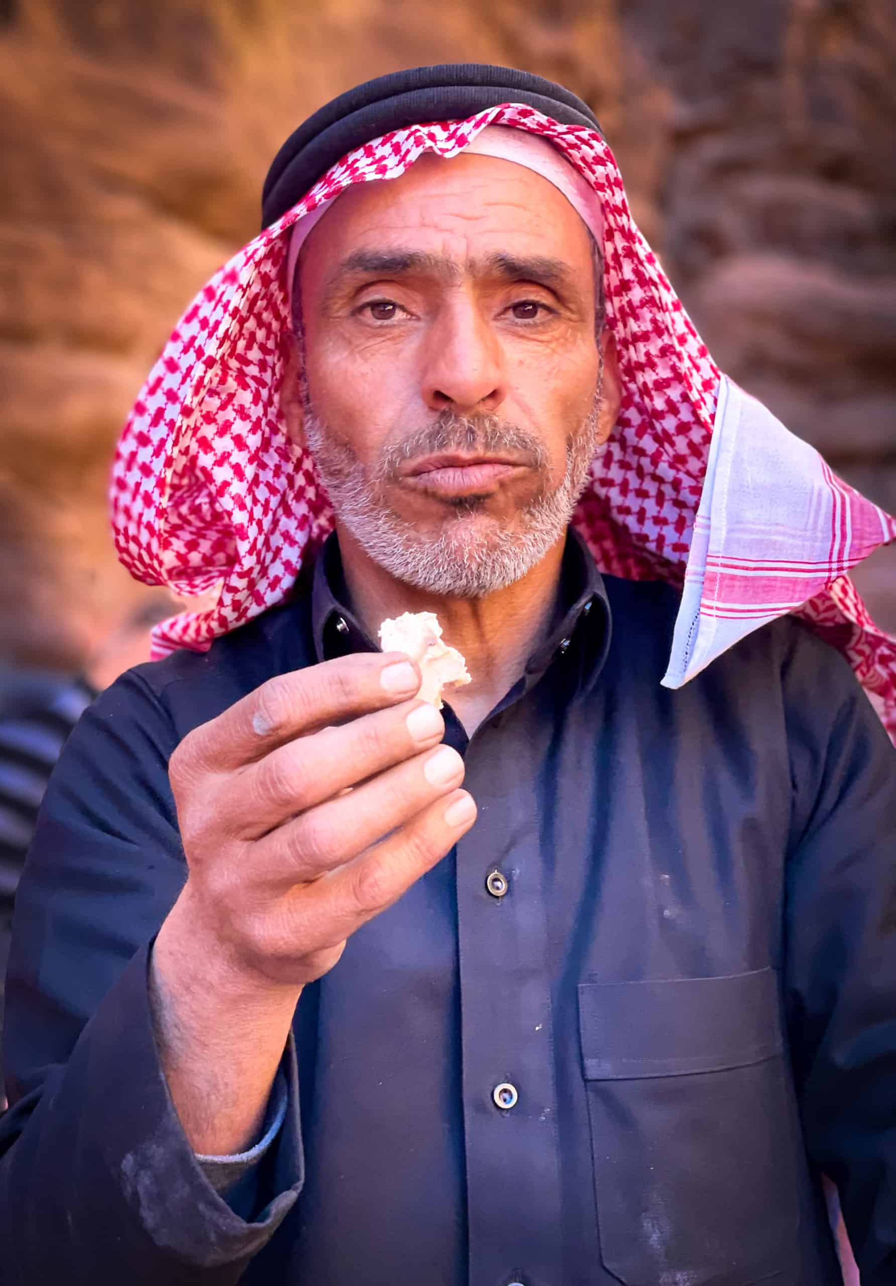 Jordan - Wadi Rum - Bedouin man offering fresh bread