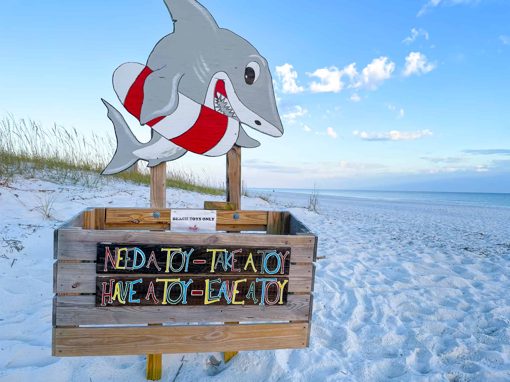 Sustainable beach tips - share beach toys box on a sandy beach in Alabama