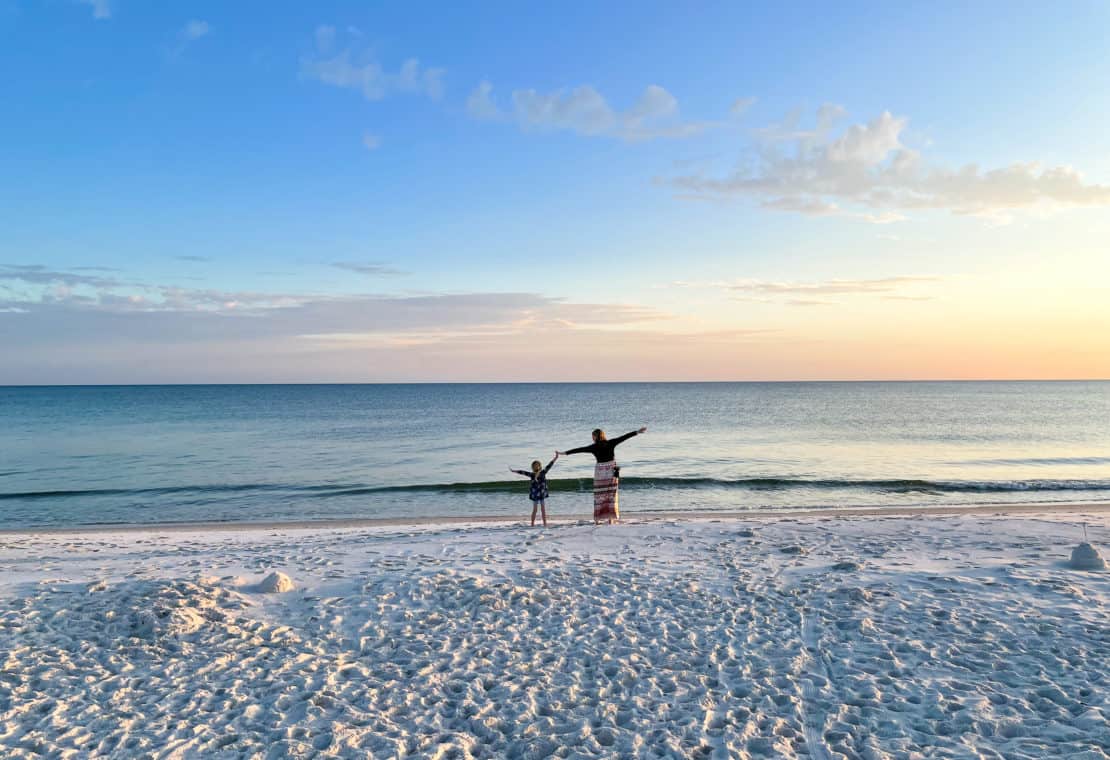 USA - Alabama - Gulf State Park beach - mother and daughter power pose