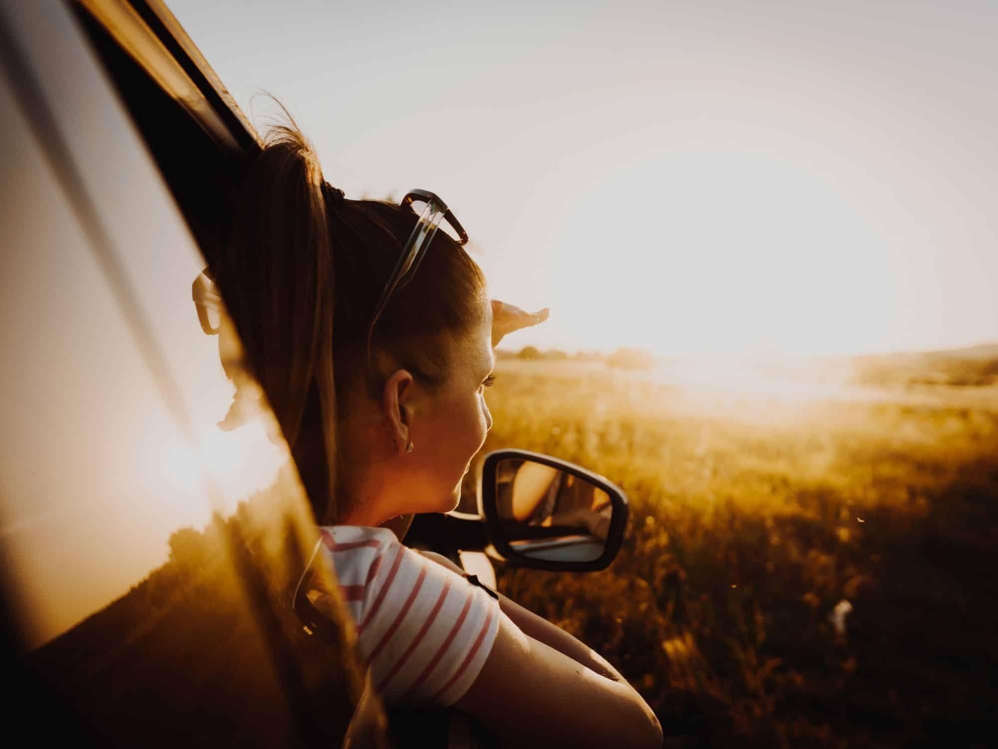 Best road trips for couples in the US woman gazing out of window