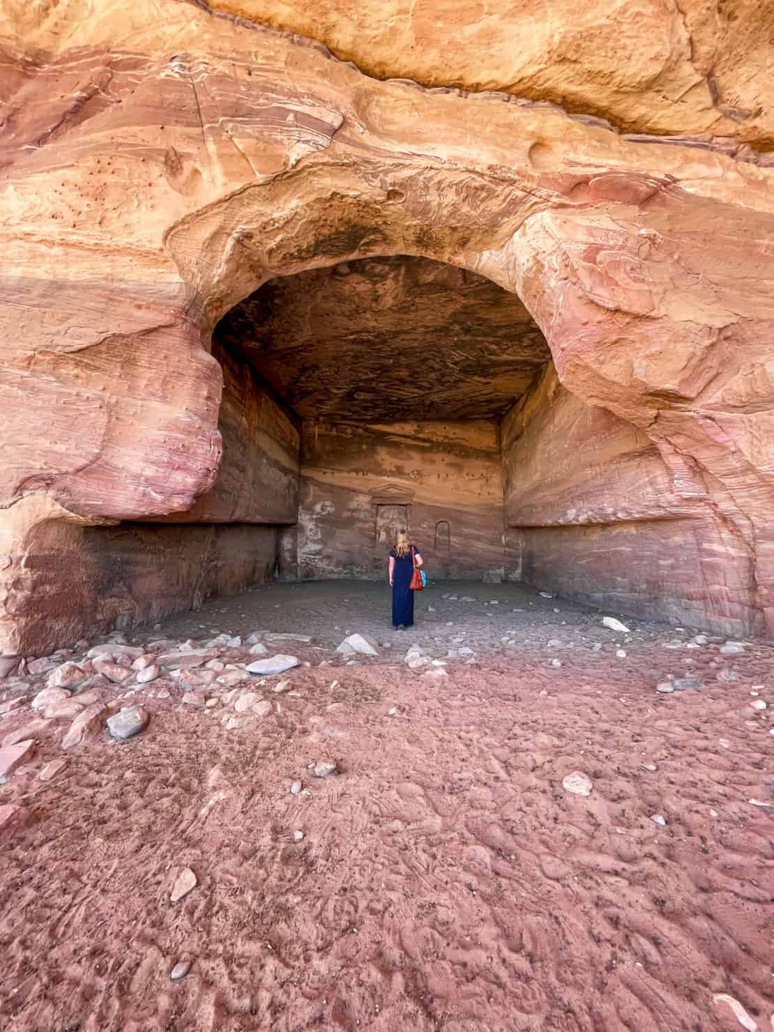 Jordan - Petra Facts - Woman in cave - Petra is big and makes people feel small