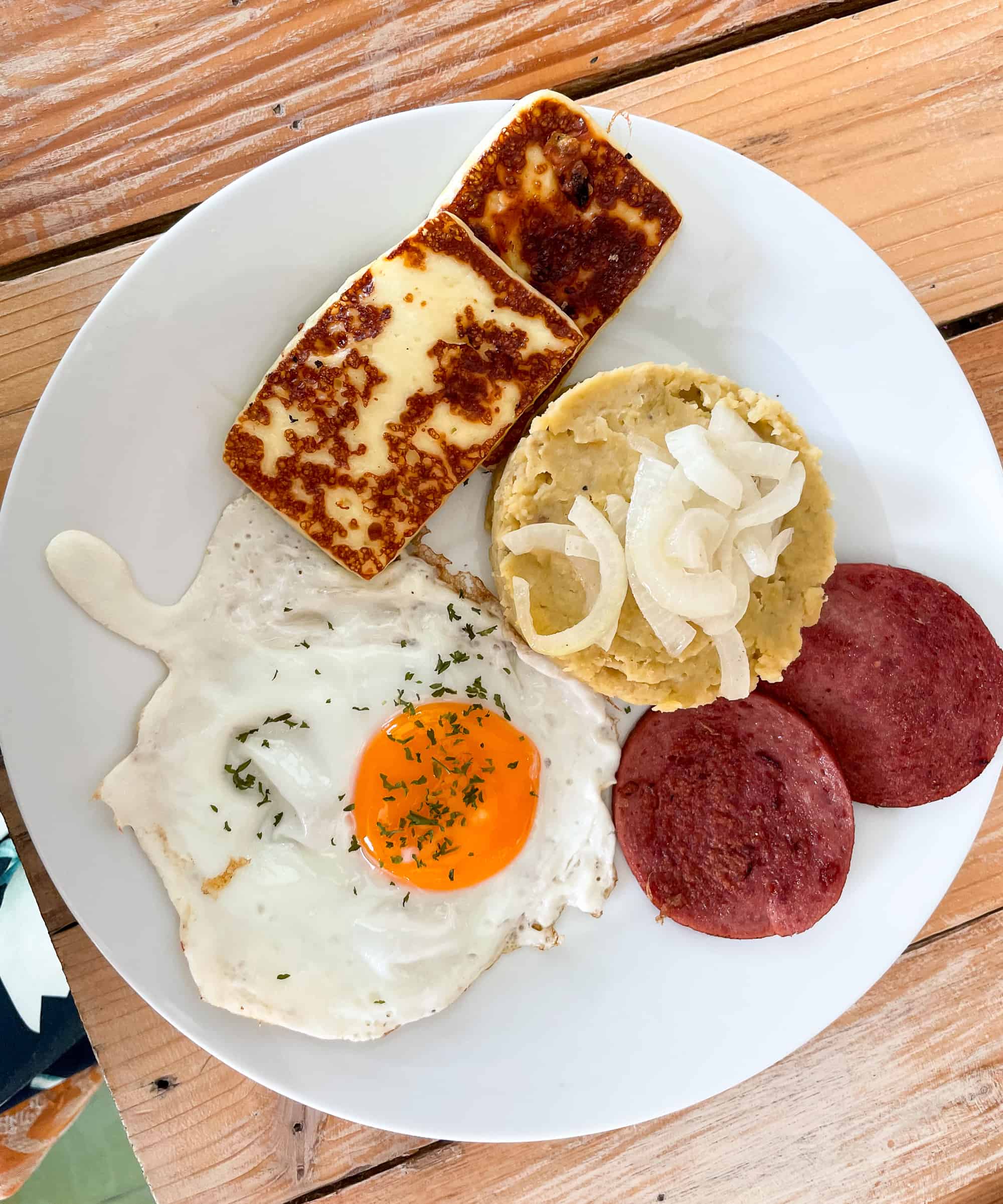 Traditional Dominican Breakfast with mangu, salami, egg and fried cheese with onions