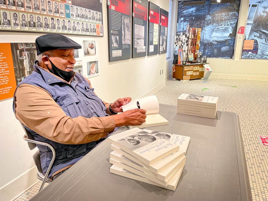 Alabama Civil Rights Trail - Freedom Riders Museum - Dr Bernard Lafayette signs his book In Peace and Freedom