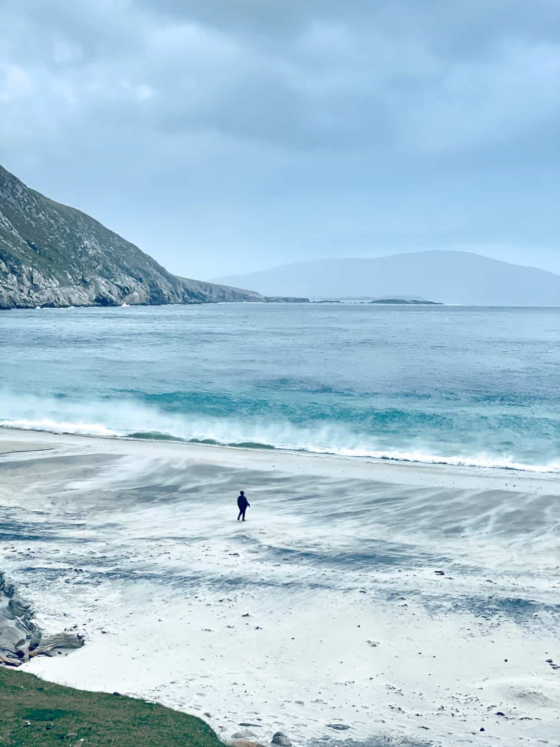 Ireland - Achill Island - Keem Beach - small figure walking on the beach in the wind