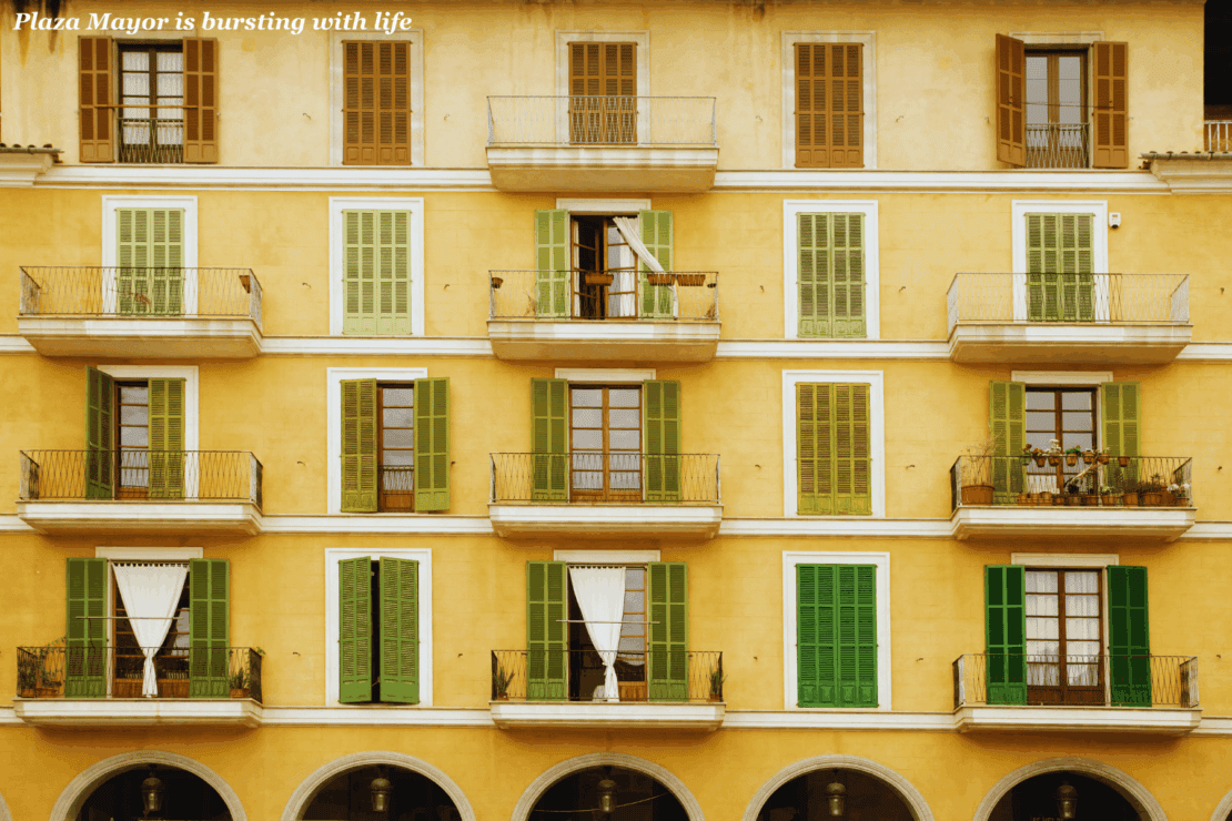 Yellow appartments with balconies in Plaza Mayor - one day in Palma de Mallorca