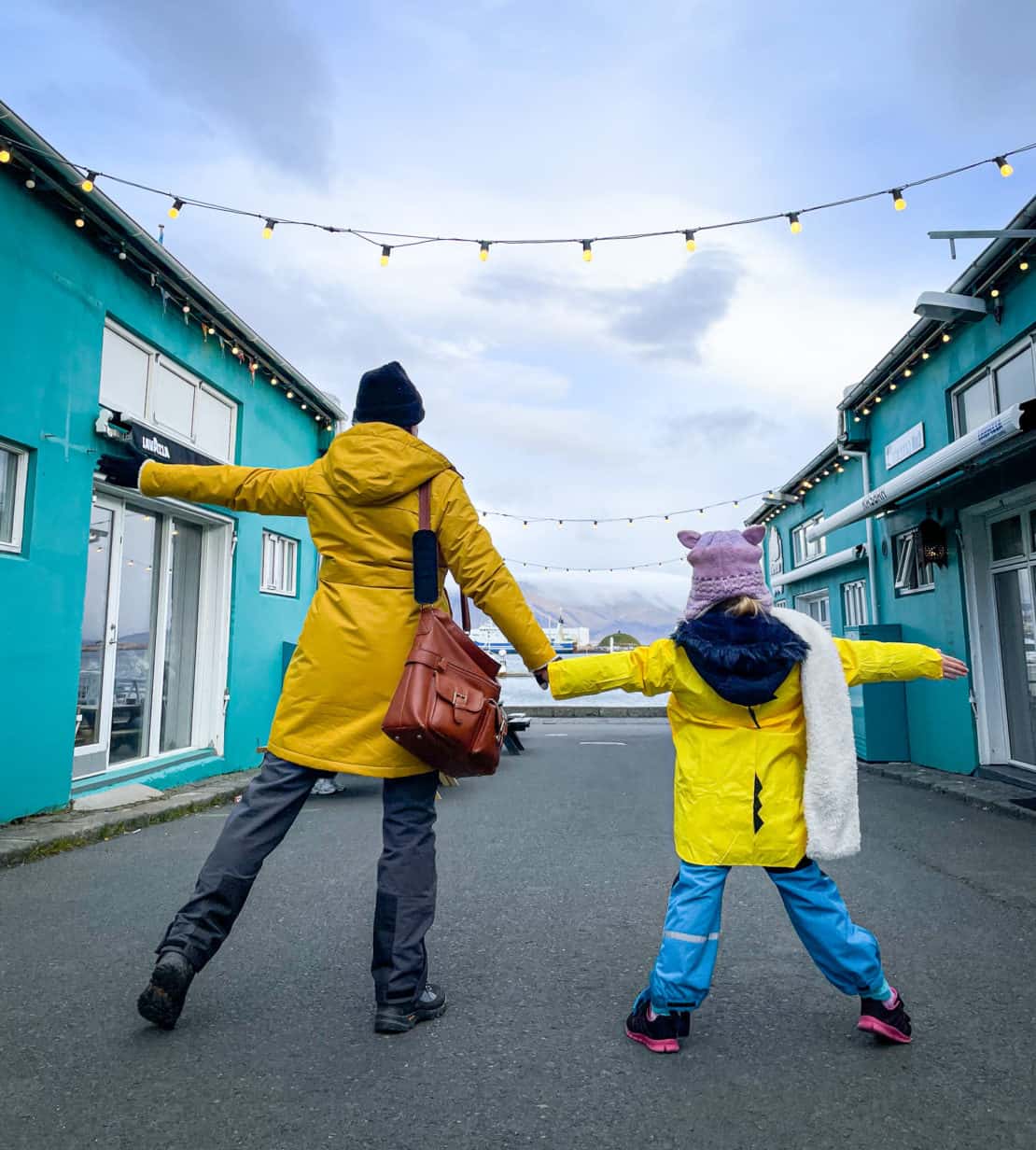 Mother and daughter playing on the street of Reykjavik - enjoying travel to Iceland with kids