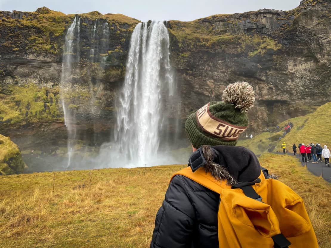 Woman looking at Selajandsfoss waterfall