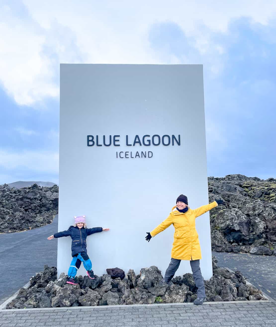 Mother and daughter standing outside the Blue Lagoon sign in Iceland