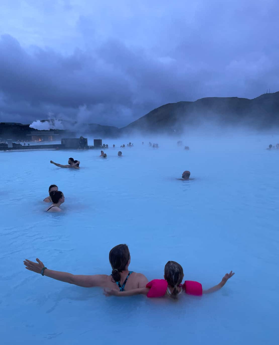 Mother and daughter amid a crowd in the Blue Lagoon in Iceland