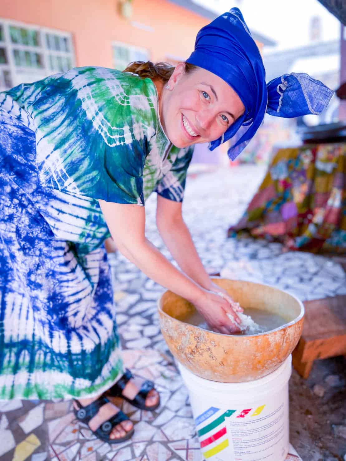 Abigail King rinses cherreh as part of a Gambian cooking class in traditional clothes