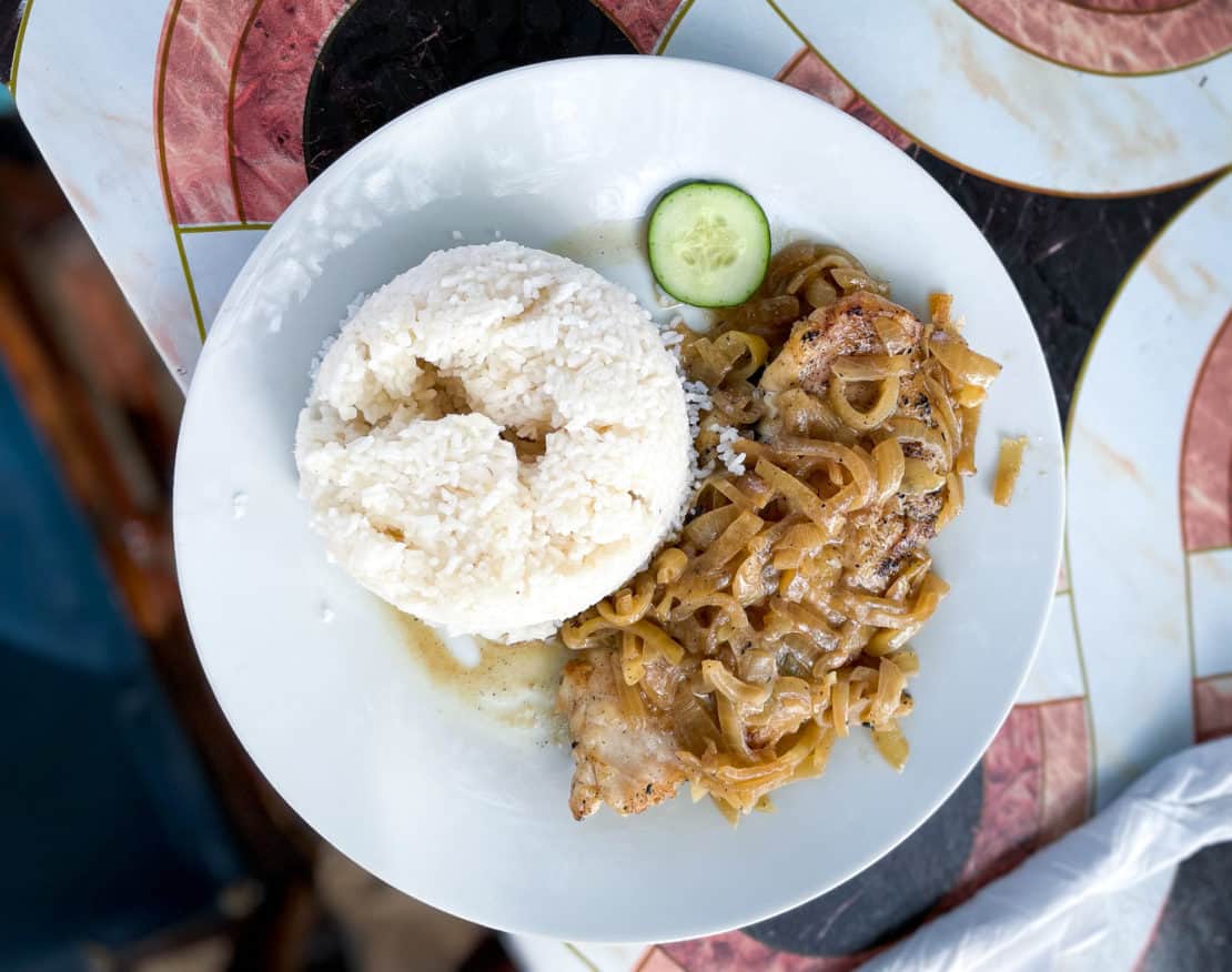 A serving of chicken yassa with rice, one of the three most popular dishes in the Gambia