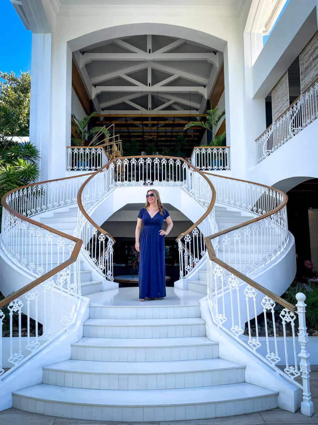 Abigail King stands on the grand staircase at the Sunlife Sugar Beach hotel in Mauritius