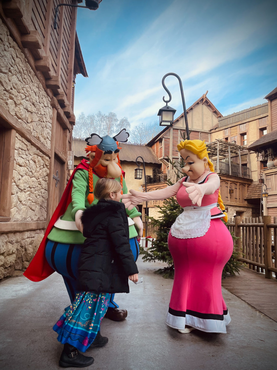 Child meeting Vitalstatistix and Impedimenta characters from Asterix and Obelix at the Parc Asterix Hotel
