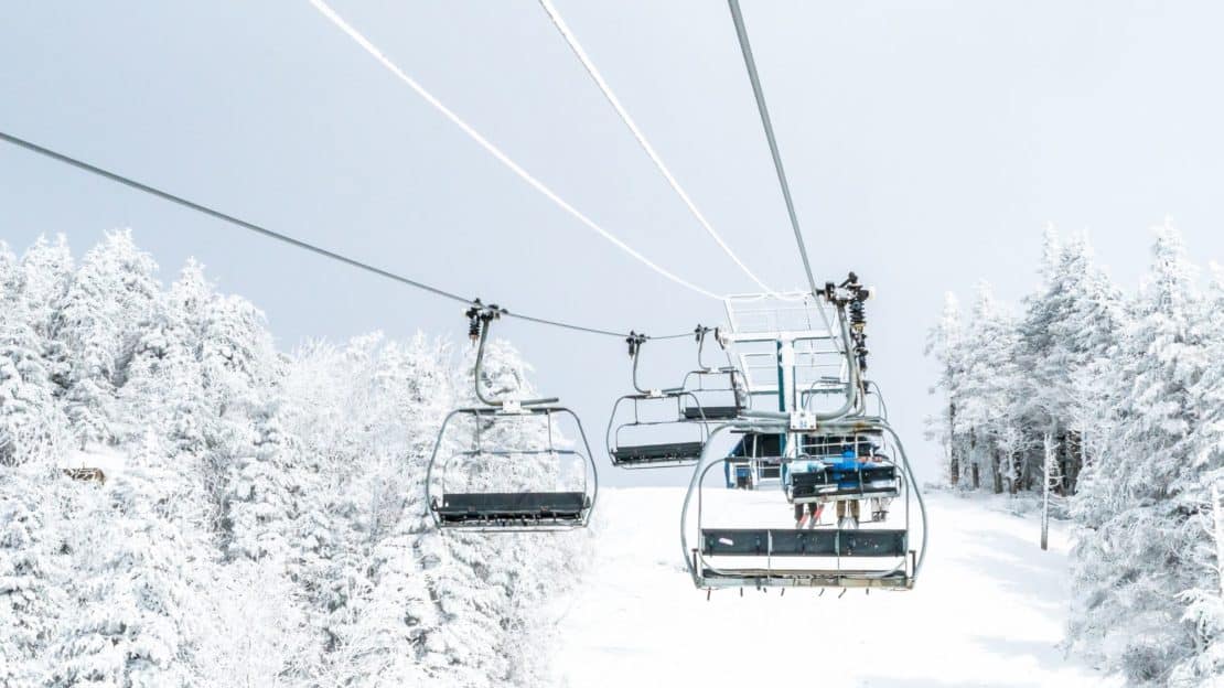 Ski chair lifts in a snowy mountain landscape