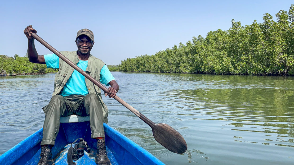 Guide on the water in The Gambia with a big smile